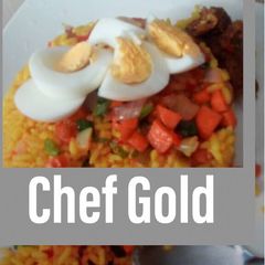 A picture of Turmeric rice garnished with veggies and boiled eggs.