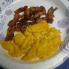 A picture of Turmeric eggs with shallots and pork belly.