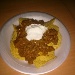 Beef chilli beans nachos w sour cream bomb AF! A picture of Beef chilli beans nachos w sour cream bomb AF!.
