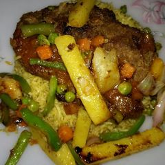 A picture of Beef Steak served with grilled veggies,sauce & Vegetables rice🔥.