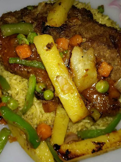 A picture of Beef Steak served with grilled veggies,sauce & Vegetables rice🔥.