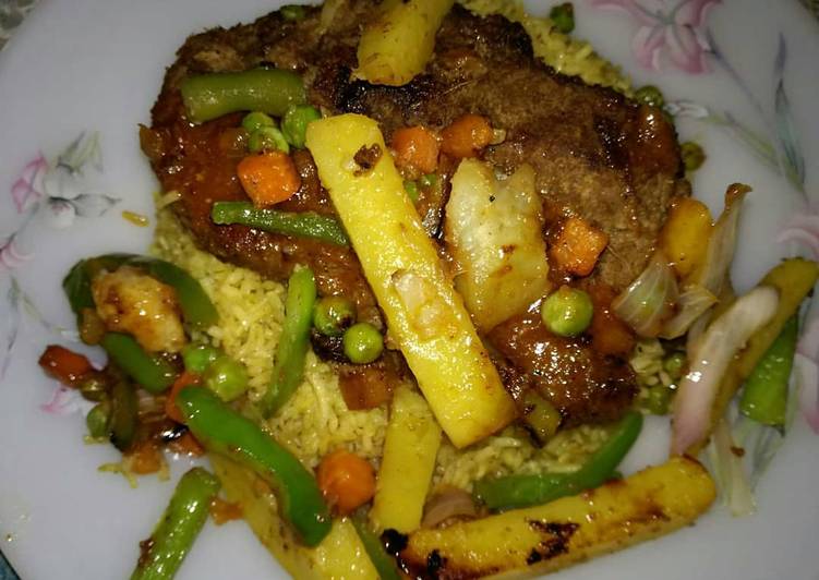 Beef Steak served with grilled veggies,sauce & Vegetables rice