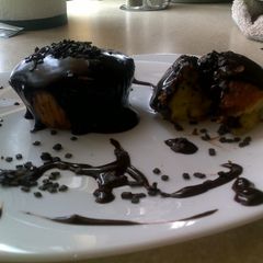 A picture of orange muffins with biter chocolate.