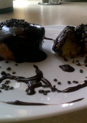 A picture of orange muffins with biter chocolate.