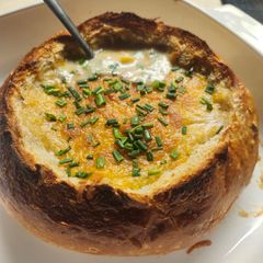 A picture of Brad's chicken, potato, and corn chowder in a sourdough bread bowl.
