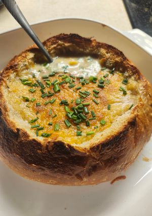 A picture of Brad's chicken, potato, and corn chowder in a sourdough bread bowl.