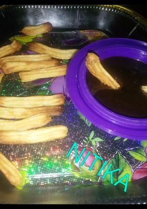 A picture of Churros with choco dip.