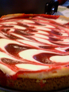 A picture of Creamy strawberry swirl cheesecake.