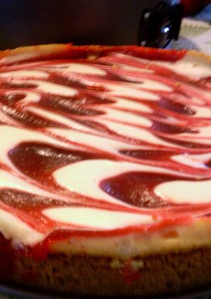A picture of Creamy strawberry swirl cheesecake.