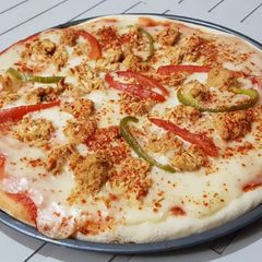 A picture of Chicken tikka white sauce cheese pizza.