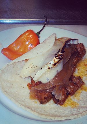 A picture of Prime rib taco with melted brie cheese.