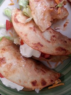 A picture of spicy shredded chicken tacos.