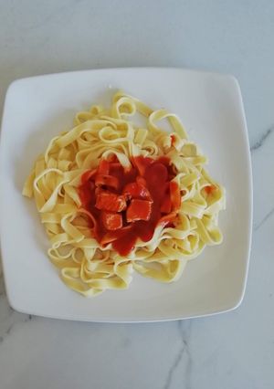 Una foto de Fideos con salsa roja y pollo 🍝