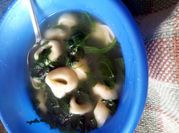 A picture of tortellini soup with spinach