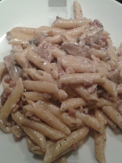 A picture of Four cheese penne with mushrooms, pancetta and toasted walnuts.