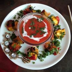 A picture of Soup with paneer tikka kabab.
