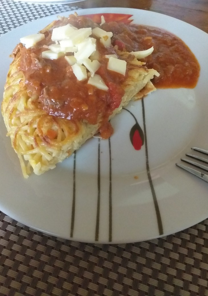 Una foto de Tortilla de tallarines acompañada con salsa
