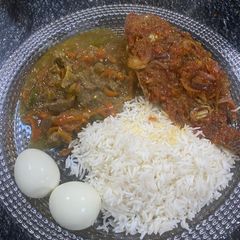 A picture of White rice, stew, peppered fish with boil egg.