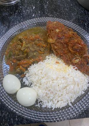 A picture of White rice, stew, peppered fish with boil egg.