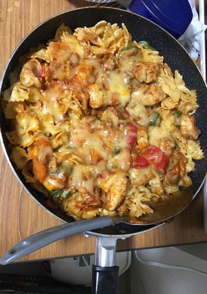 A picture of Chicken breast on Rigate cheese pasta.