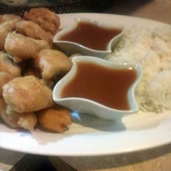 A picture of Sweet and sour sauce with chicken tempura.