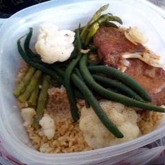 A picture of Bourbon salmon with mixed veggies and brown rice.