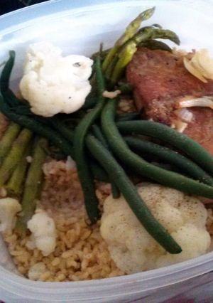 A picture of Bourbon salmon with mixed veggies and brown rice.