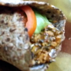 A picture of High protein spicy chicken spinach wrap.