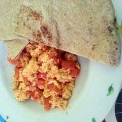 A picture of Scrambled Eggs with Tomatoes.