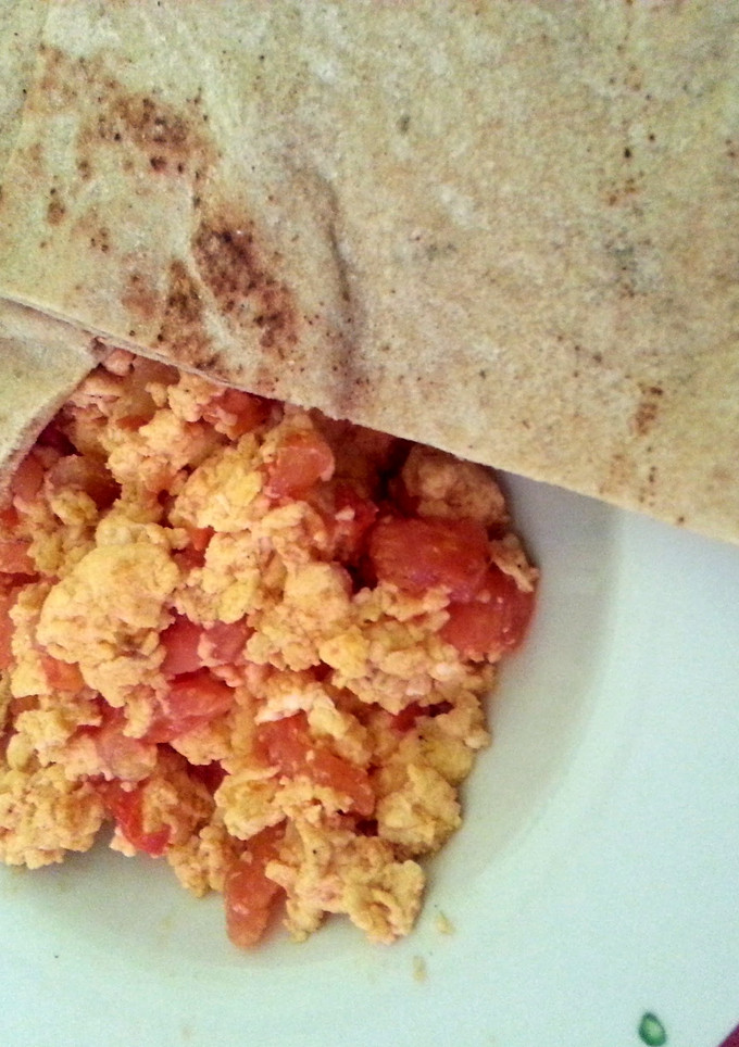 A picture of Scrambled Eggs with Tomatoes.