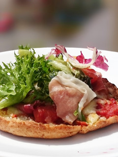 A picture of Proscuitto Pizza On Pita Bread Top Salad.