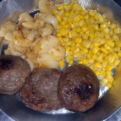 A picture of round breakfast sausage with potatoes.