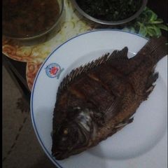 A picture of Fried fish,sukuma and stew.