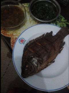 A picture of Fried fish,sukuma and stew.