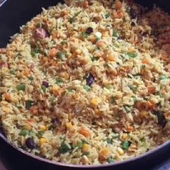 A picture of Jollof rice with vegetables.