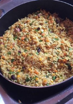 A picture of Jollof rice with vegetables.