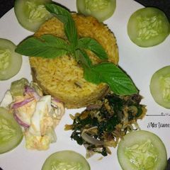 A picture of Jollof Rice with Coleslaw and Dried Fish.