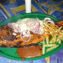 A picture of Grilled fish with irish potatoes and cucumber.