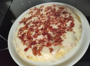 Foto principal de Tortilla de patatas rellena de jamón serrano y topping de alioli y jamón crujiente