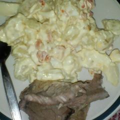 A picture of Steak with potato salad.