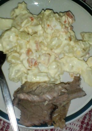 A picture of Steak with potato salad.