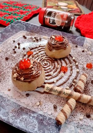 A picture of Coffee panacotta with hazelnut spread spirals and crushed wafers.
