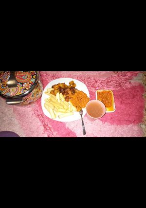 A picture of Fried yam and plantain with egg sauce and natural pineappl juice.