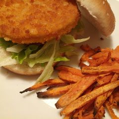 A picture of Chicken burger with Cajun spiced sweet potato chips.
