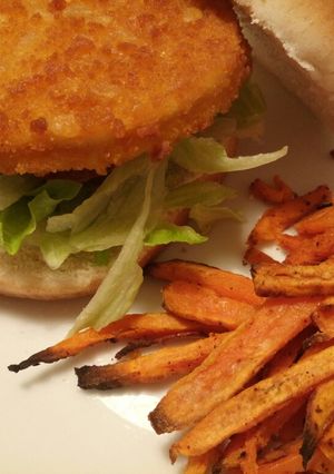 A picture of Chicken burger with Cajun spiced sweet potato chips.