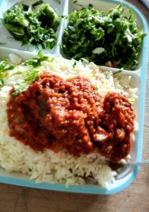A picture of Rice and Stew with salad. # kano.