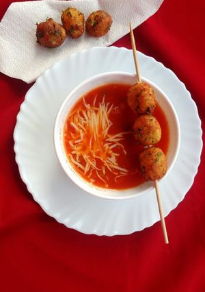 A picture of Mexican tomato soup with cottage cheese balls.