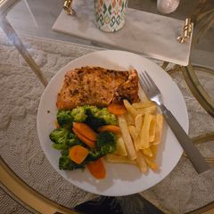 A picture of Salmon with Crunchy Veggies and French Fries.