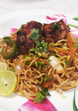A picture of Peri peri noodles with pan fried chicken.