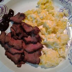 A picture of Breakfast steak and eggs.